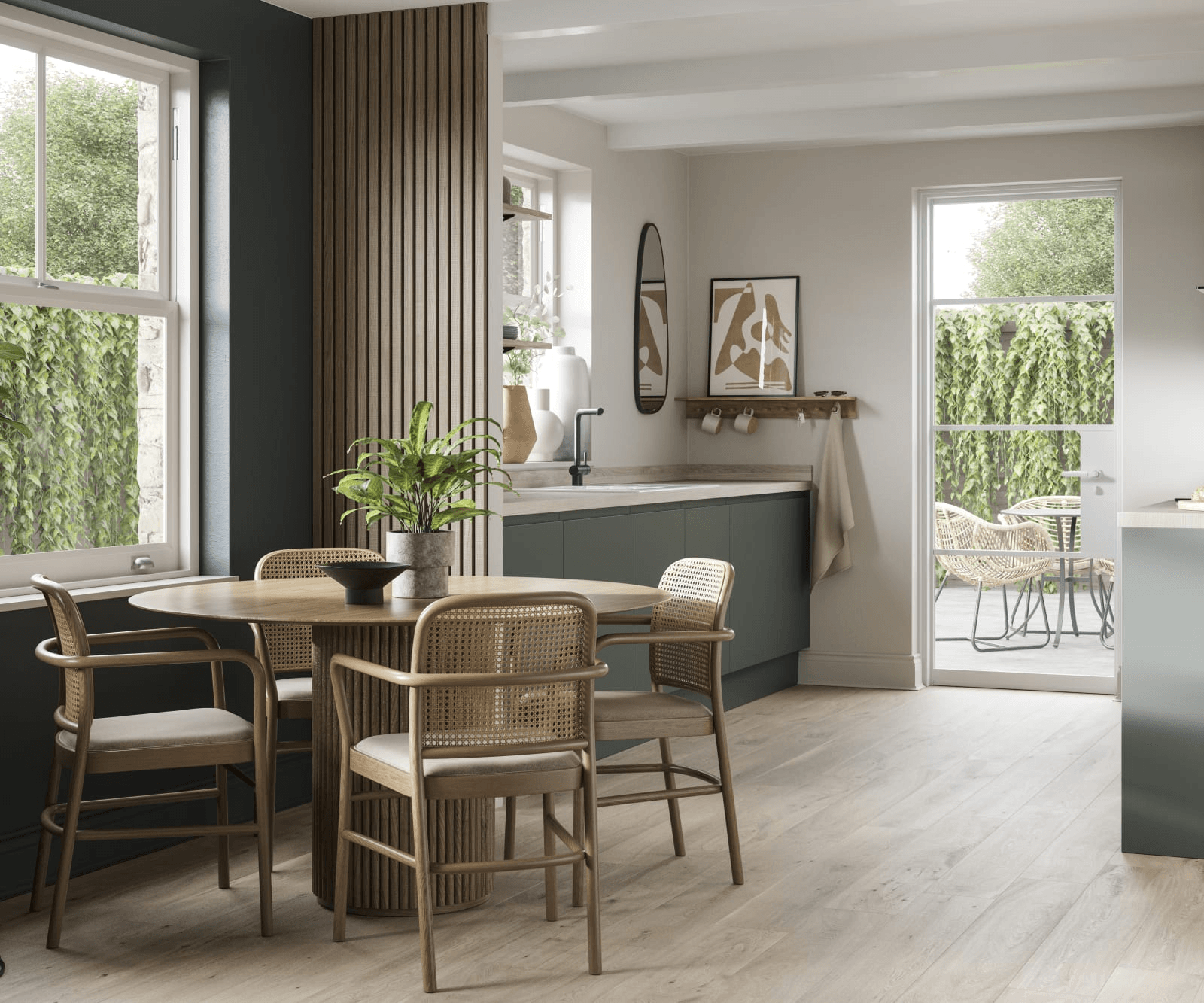 {"image_loaded": true, "load_issue": null, "description": "The image shows a modern kitchen dining area with a round wooden table surrounded by four matching wooden chairs with woven backrests and light-colored cushions. A potted green plant sits on the table. The kitchen cabinetry is shown in a muted greenish-gray color with light countertops. Behind the table, there is vertical wood panel detailing on the wall. Two windows and a glass door provide views of an outdoor area with greenery and patio furniture. Inside, there are minimalist decorative elements like vases on floating shelves, a round mirror, and abstract framed artwork above a small wall-mounted shelf with cups and a hanging towel. The flooring is light wood, and the lighting is natural and bright, coming primarily from the windows. The camera angle is eye-level with a medium-wide framing that captures the dining table, kitchen cabinets, and part of the outdoor space.", "people": null, "setting": {"environment_type": "indoor", "location_hints": "kitchen dining area with windows and glass door showing an outdoor patio with greenery and wicker furniture", "depth_scale": "medium", "lighting": "natural bright lighting from windows", "temperature": "neutral"}, "objects": {"primary_objects": ["round wooden dining table", "four wooden dining chairs with woven backs", "potted plant on table", "kitchen cabinets", "sink with faucet", "vases on shelves", "round wall mirror", "framed abstract art", "wall-mounted shelf with cups", "towel hanging", "patio table and wicker chairs outside"], "secondary_objects": ["black bowl on dining table", "sunglasses on wall shelf"], "object_interaction": null}, "composition": {"subject_focus": "round dining table with chairs in foreground, kitchen cabinetry and windows in midground, outdoor patio visible through glass door in background", "relationships": "dining table centered in room with chairs evenly spaced around it; cabinetry and decorative elements line walls; windows and door frame outdoor view symmetrically", "depth_structure": "clear separation between foreground dining setup, midground kitchen, and background outdoor scene; overall sharp focus", "camera_angle": "eye-level", "cropping": "medium-wide framing capturing entire dining area and part of kitchen and outdoor space"}, "motion": {"motion_type": "static", "motion_direction": null, "energy_level": "low", "sequence_implied": "single moment"}, "aesthetic": {"medium": "photograph", "style_subtype": "realistic, minimalistic interior design", "color_palette": "muted neutrals with natural wood tones and green accents", "contrast_level": "moderate", "texture_and_grain": "smooth surfaces with natural wood grain texture visible", "postprocessing": "natural lighting with soft shadows, no heavy filters"}, "tone": {"visual_mood": "calm, clean, modern", "lighting_influence": "bright and natural, creating an inviting atmosphere", "camera_distance_effect": "intimate yet spacious"}, "confidence": {"demographic_confidence": null, "activity_confidence": null, "setting_confidence": 0.95}}