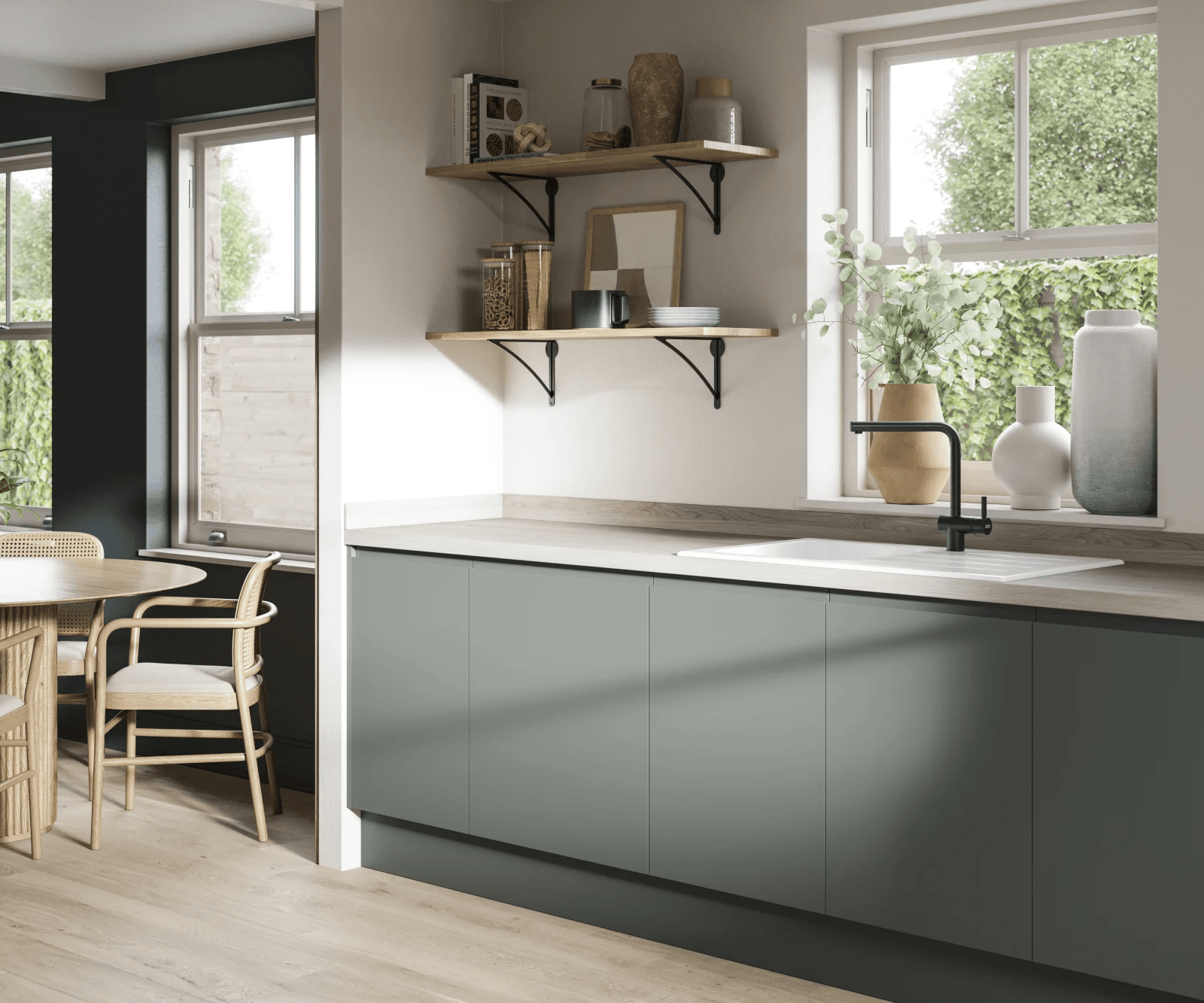 {"image_loaded": true, "load_issue": null, "description": "The image shows a modern kitchen corner with a wooden dining table and chairs on the left and a countertop with cabinets on the right. There are two large windows with white frames, allowing natural light to enter. On the countertop, there is a white sink with a black faucet and three decorative vases with green foliage near the right window. Above the countertop, two wooden shelves are mounted on the wall, holding various jars, decorative items, books, a cup, and stacked plates. The cabinets below the countertop are matte green. The flooring is light wood, complementing the natural and neutral color scheme.", "people": null, "setting": {"environment_type": "indoor", "location_hints": "kitchen with wooden flooring, large windows with outdoor greenery visible, kitchen countertop with sink", "depth_scale": "medium", "lighting": "natural daylight from windows", "temperature": "neutral"}, "objects": {"primary_objects": ["dining table", "wooden chairs", "kitchen countertop", "sink", "black faucet", "decorative vases", "green foliage", "shelves", "jars", "books", "cup", "plates"], "secondary_objects": ["wood flooring", "window frames"], "object_interaction": "no people visible; objects are arranged for decoration or use"}, "composition": {"subject_focus": "kitchen corner with dining area and countertop", "relationships": "dining table and chairs on the left; countertop and sink on the right, shelves centered above countertop", "depth_structure": "foreground features dining table and chairs; mid-ground is countertop and cabinets; background is window and outdoor greenery", "camera_angle": "eye-level", "cropping": "medium wide shot"}, "motion": null, "aesthetic": {"medium": "photograph", "style_subtype": "realistic, modern interior", "color_palette": "muted, natural tones", "contrast_level": "moderate", "texture_and_grain": "smooth surfaces, matte cabinet finish", "postprocessing": "natural lighting with slight softening"}, "tone": {"visual_mood": "calm and clean", "lighting_influence": "bright natural light", "camera_distance_effect": "moderate, functional view"}, "confidence": {"demographic_confidence": null, "activity_confidence": null, "setting_confidence": 0.95}}