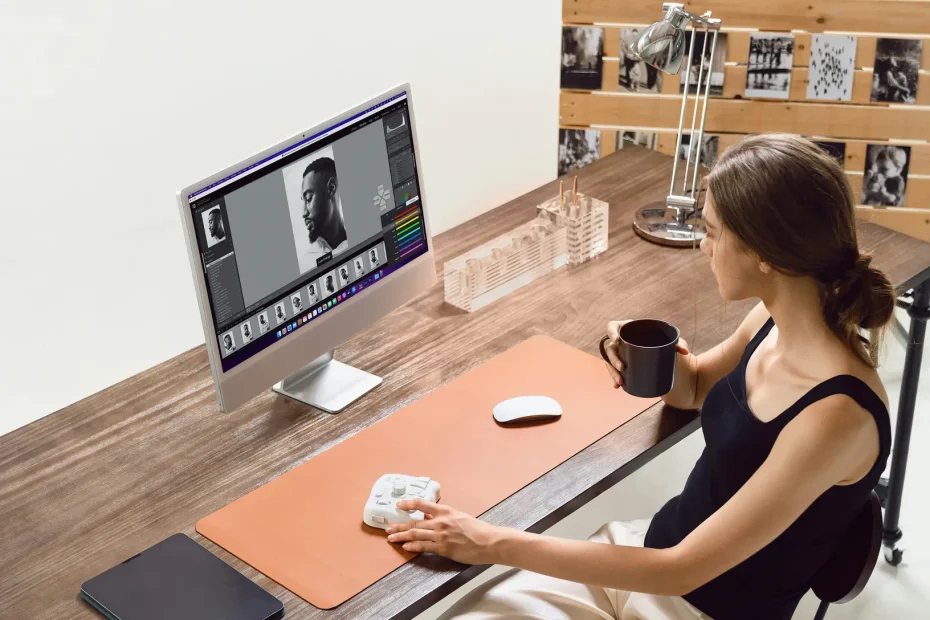 A woman edits photos at her desk.