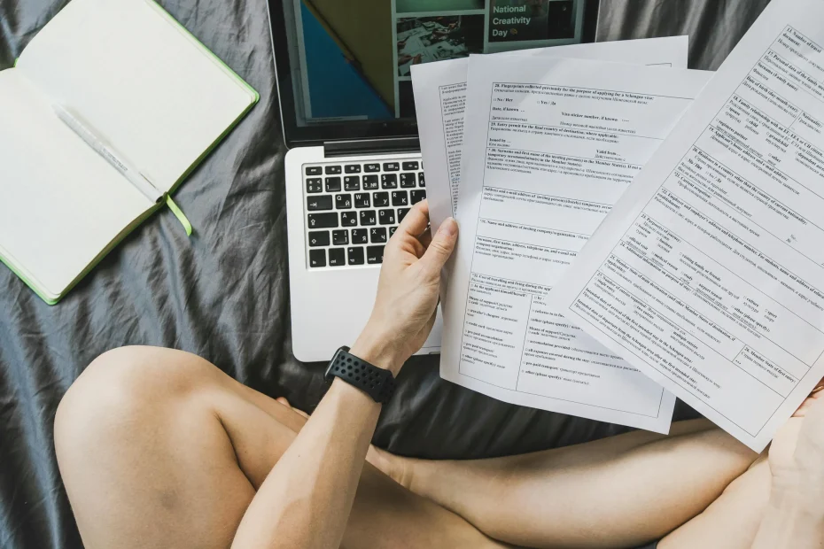 Freelancer managing documents on a laptop from home for productivity.